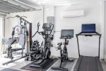 Home Features a Small Gym in Garage which has AC 